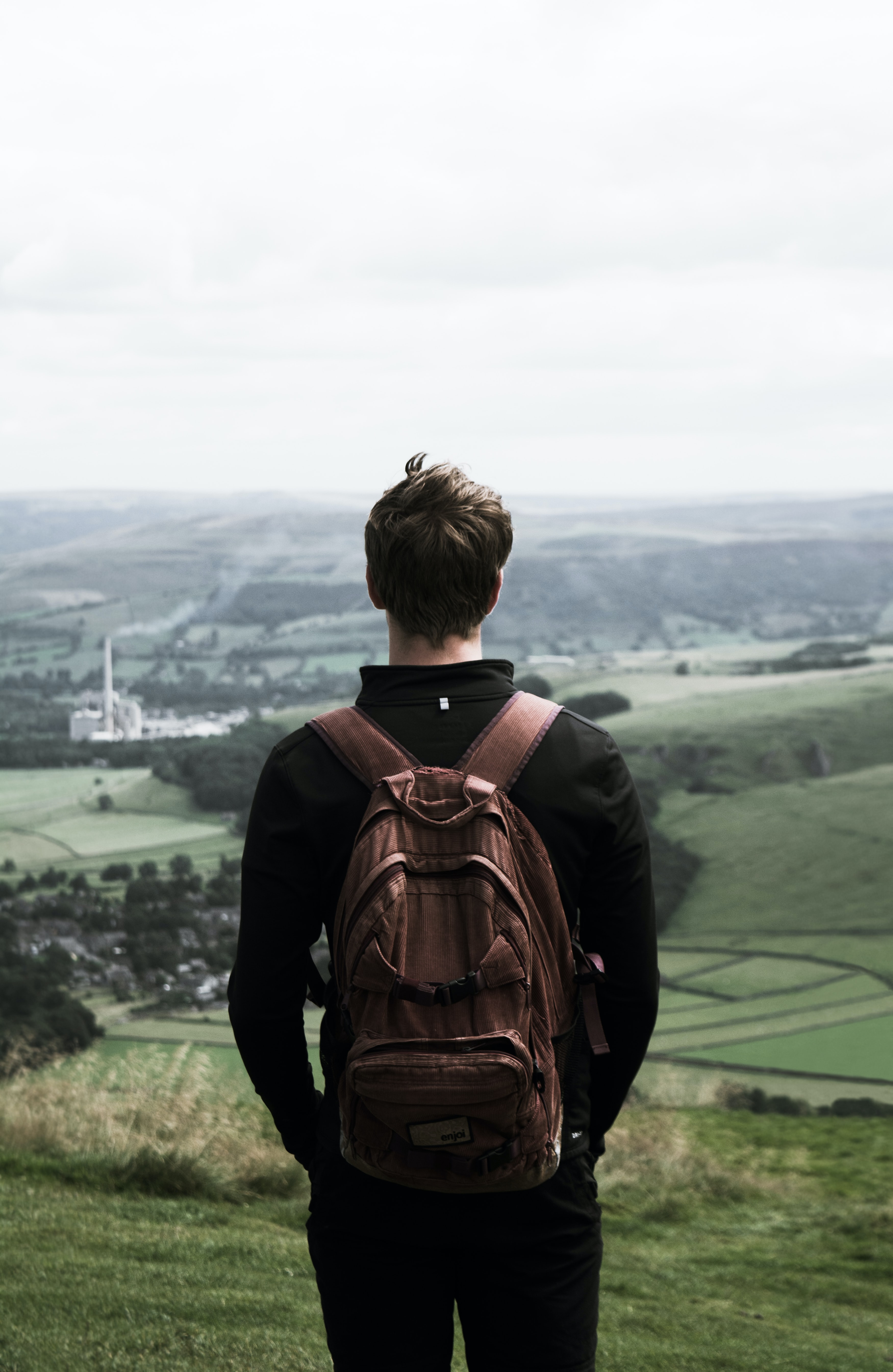 Young man on high ground gazing the view