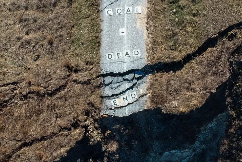 Mining view from the top with "Coal is a dead-end" message