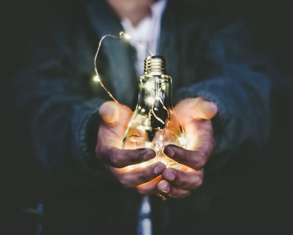 Dirty man's hand holding a lamp