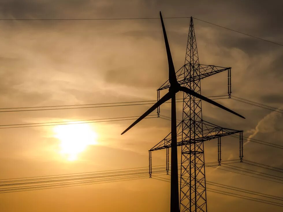 Wind turbine and high-voltage lines in the background