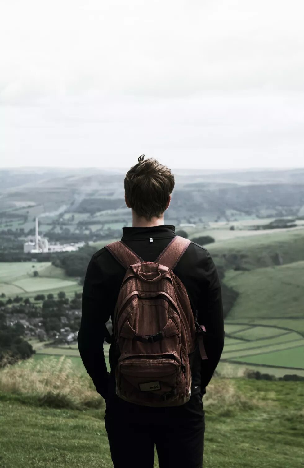 Young man on high ground gazing the view